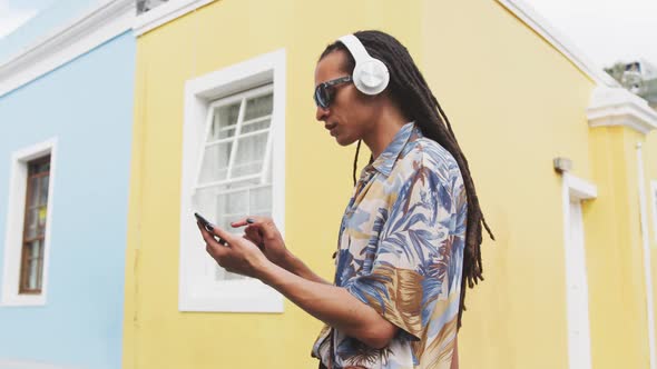 Mixed race man listening to music with headphone