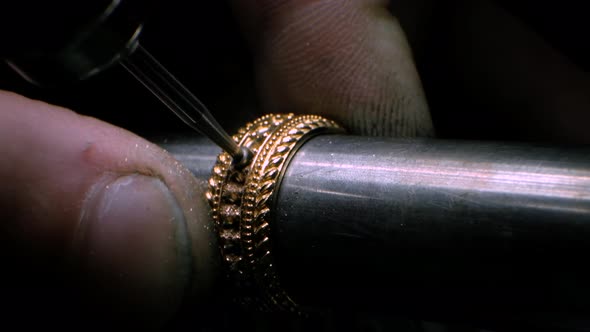 Goldsmith Using a Drill Tool to Make a Hole in Golden Ring