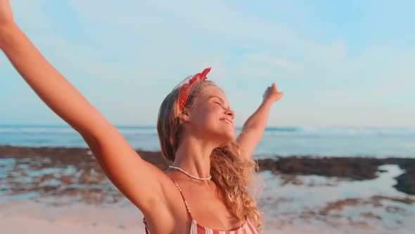 Young Pretty Caucasian Woman in Swimsuit Enjoying Last Evening Sun on Beach