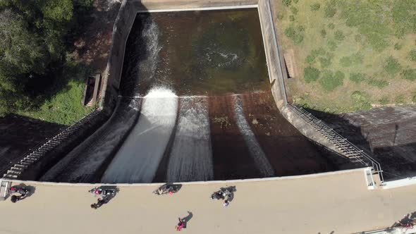 Bird's eye view of Mattupetty Dam and crossing tourists near Munnar in South India