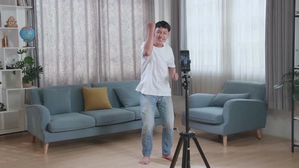 Asian Boy Dancing While Shooting Video Content For Social Networks With A Smartphone Camera