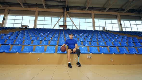 A Basketball Player with Prosthetic Leg Sits, Close Up