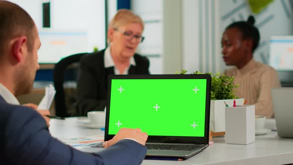 Back View of Business Man Sitting Conference Desk Using Laptop with Green Screen