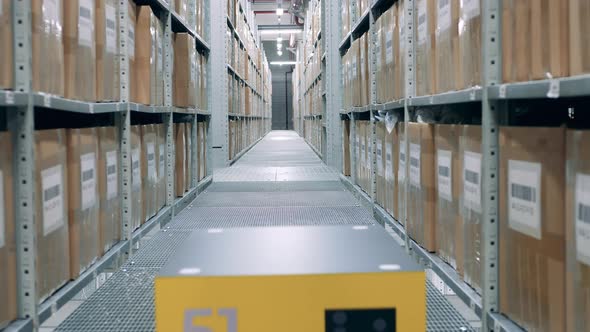 Warehouse with a Robotic Machine Riding Through It