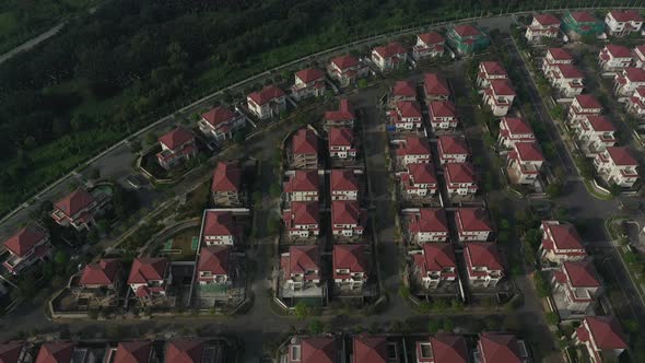 Aerial view of ultra modern lakeside housing and apartment development on a sunny day with park, gre