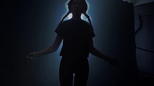 Young Woman Training with a Jumping Rope