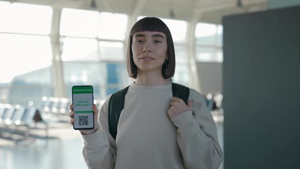 Woman Showing Certificate with Immunity for Covid on Mobile