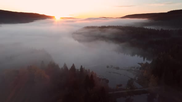 Aerial view of sunrise with fog above lake Schluchsee, Germany