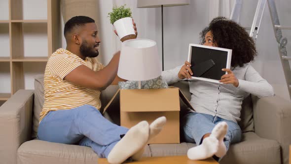 Happy Couple with Boxes Moving To New Home