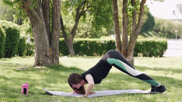 The Athletic Woman Is Doing Morning Gymnastics Outdoors