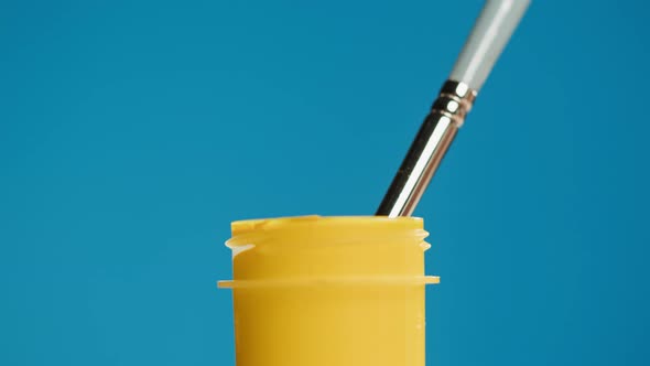 Yellow Paint Isolated on Blue Background