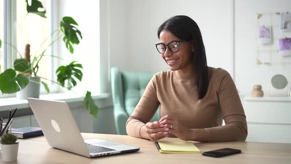 Woman Having Online Conversation at Table and Staying in Home Room During Pandemic Spbd