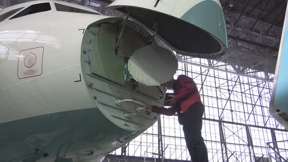 Engineer Repairs Locator Passenger Aircraft