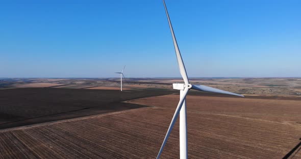 Large White Wind Turbines On Wind Farm At Daytime