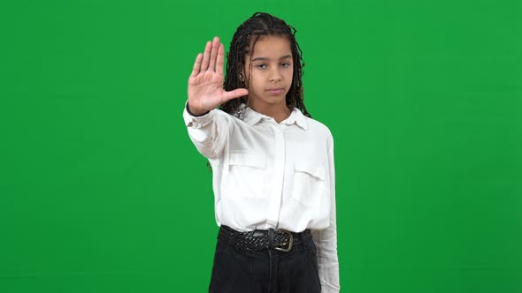 Confident Serious African American Teenage Girl Stretching Hand to Camera Stop Gesture Shaking Head