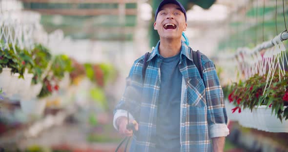 Cheerful Farmer Spraying Herbicide at Farm