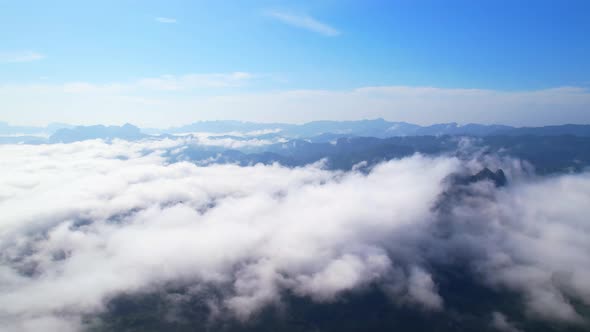 An aerial view from a drone flying over the many fogs in the mountains