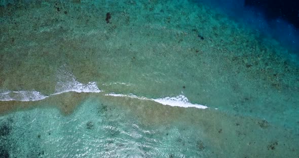 Beautiful drone tourism shot of a sunshine white sandy paradise beach and blue sea background in vib