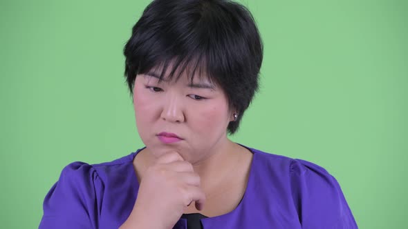 Face of Stressed Young Overweight Asian Woman Thinking and Looking Down