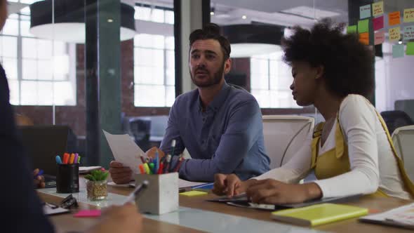 Mixed race business colleagues sitting having a discussion in meeting room