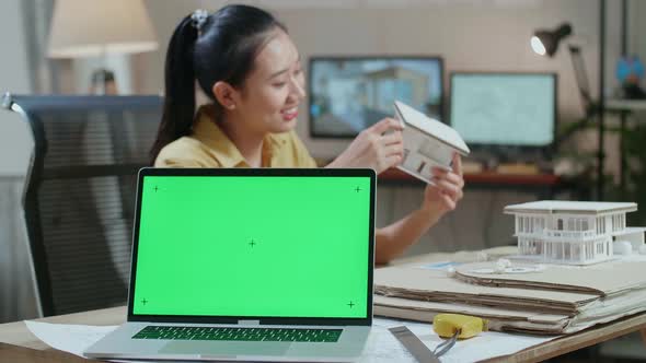 Laptop Green Screen With Asian Woman Engineer Making Paper Model Of House At The Office
