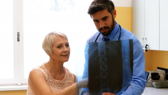 Doctor discussing x-ray with patient