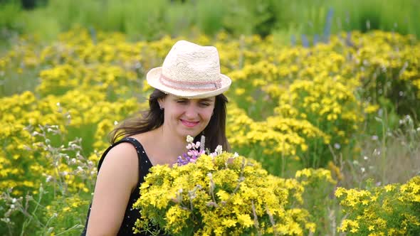 Happy Woman Looking at Bouquet of Wildflowers