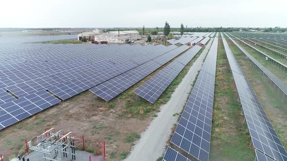 Drone Footage of Long Rows of Solar Panels in the Field Power Station