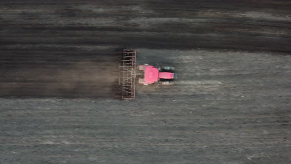 Agricultural Tractor Plows Soil Field for Sowing  Aerial Top View From the Drone