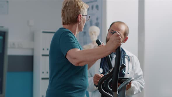 Senior Patient Doing Recovery Exercise at Appointment