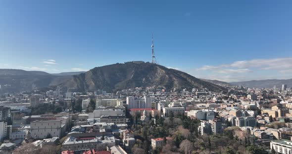 Tbilisi, Georgia - February 1, 2022: Aerial view of center of Tbilisi under Mtatsminda mountain.