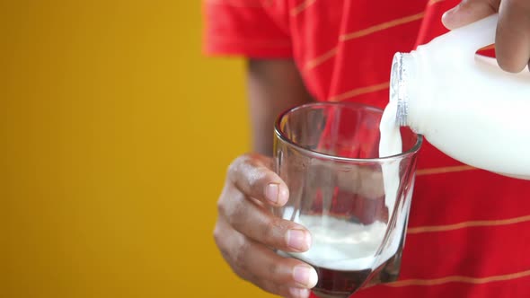 Child Boy Hand Hold a Glass of Milk