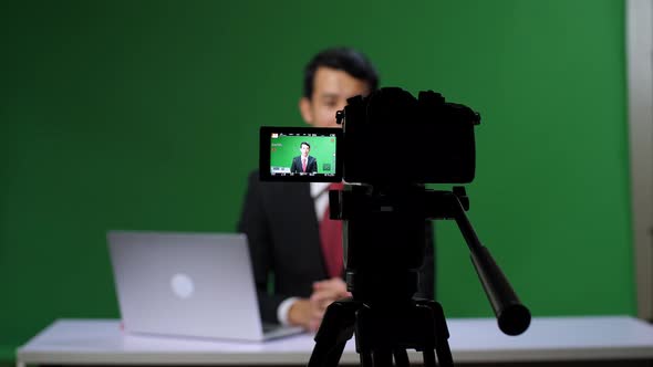 Camera Record Professional Asian Male Anchor Reporting On Green Screen At Home Studio