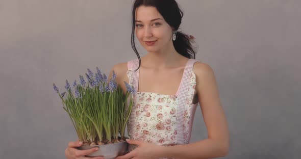 Woman Holding Bouquet of Flowers in Hands Indoors