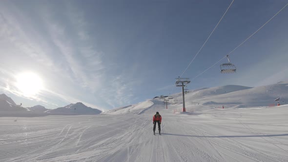 Man skiing on snowy slope at ski resort in the mountains