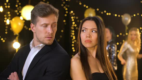 Upset Young Couple Looking Each Other in Night Club, Relations Conflict, Quarrel