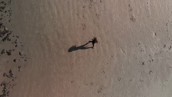 Aerial Top View Pretty Gymnast Woman Practices Cartwheel and Split on Sunny Sandy Beach