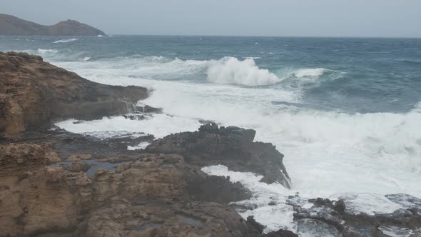 Raging waves crashing on rocky coast at Porto dos Frades, Porto Santo island. Madeira