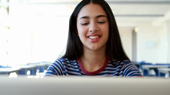 Student using laptop in classroom