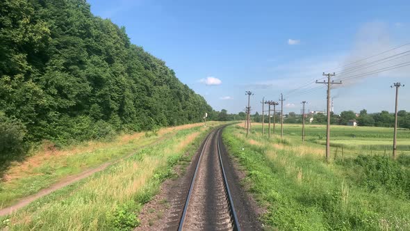 Blured Side View of Highspeed Turning End Back of Train on Landscape of Beautiful Nature Wild Field