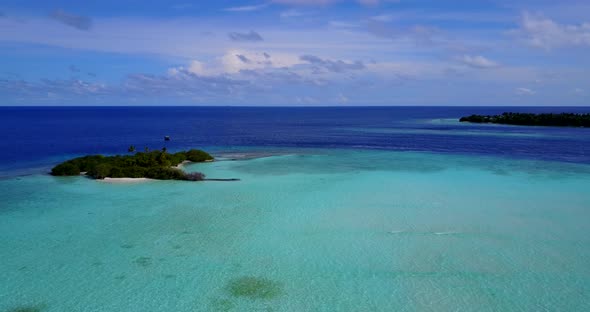 Tropical overhead island view of a white paradise beach and aqua blue water background in colourful 