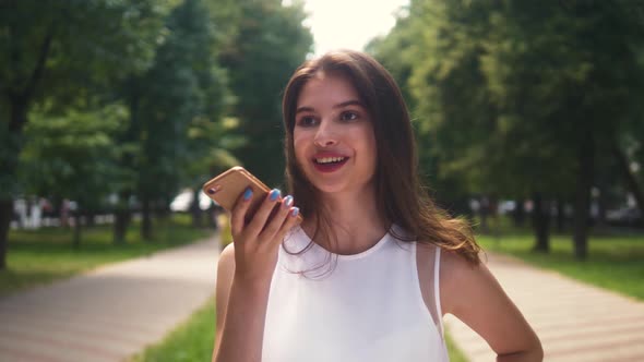 Girl Using Smart Phone Voice Recognition, Dictates Thoughts, Voice Dialing Message at Night Evening