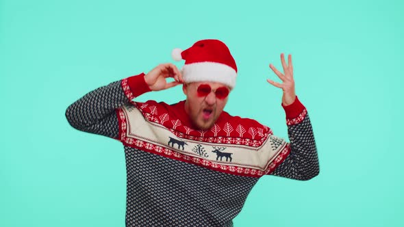 Man in Christmas Sweater Listening Music Via Earphones Dancing Disco Fooling Around Having Fun