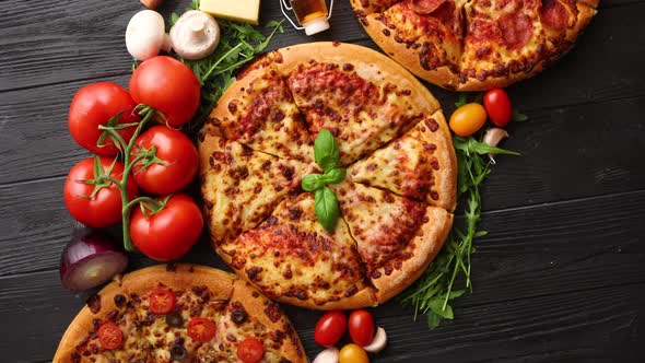 Freshly Served, Three Various Pizzas Placed Among Tasty Ingredients. Top View