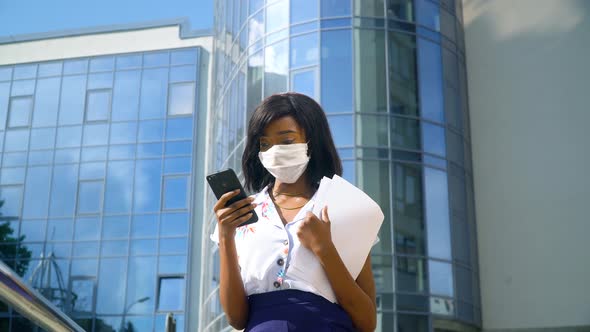 Elegant Beautiful African American Businesswoman in Protection Mask Using Social Networks on Her