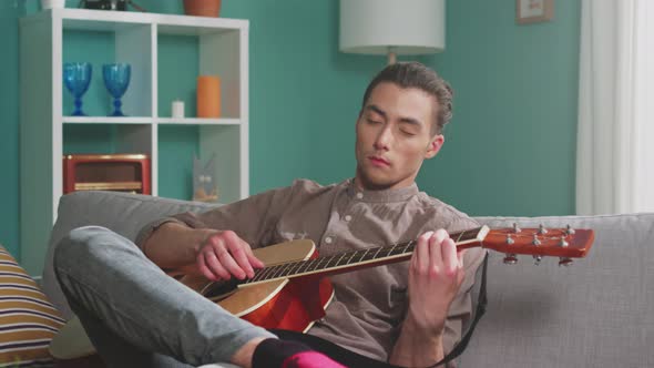 Man With Closed Eyes Is Playing Guitar