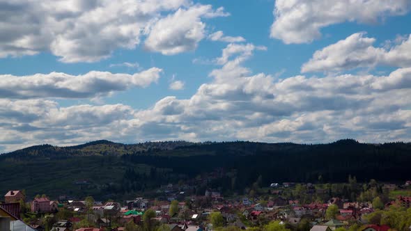 Clouds Form in Blue Sky Over Small Village. Time Lapse