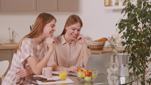 Happy Twins Talking on Video Call in Kitchen