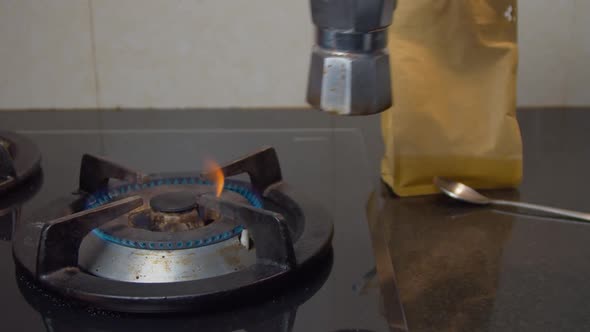 Hand Of A Man Take out The Freshly Brewed Coffee On The Moka Pot On The Gas Stove.-medium shot