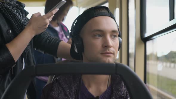 Young Man Listening to Music during Commute Home